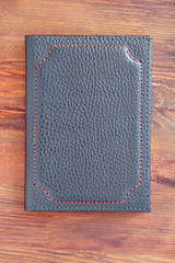 leather cover for documents on a wooden background