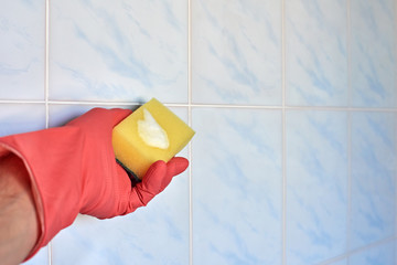 Cleaning and housekeeping concept. Hand in pink glove cleaning dirty ceramic tile