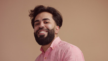 Obraz premium man touches his hair an looking at camera. Good groomed man with beard