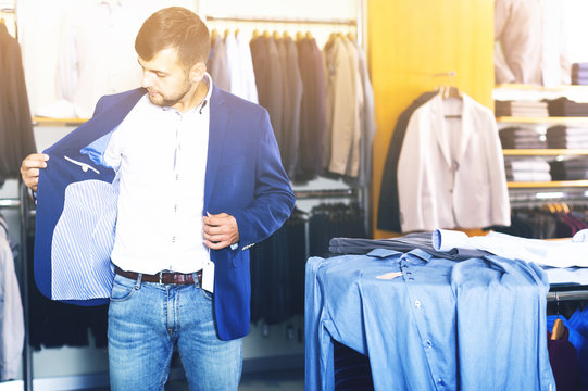 Ordinary male customer choosing jacket