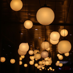 Ceiling lights of spherical shape on dark background