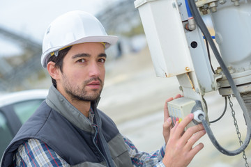 Portrait of man operating machinery on construction site