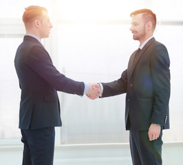 handshake financial partners in the corridor of the office