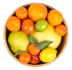 Isolated citrus fruits. Grapefruit, orange, lemon, lime and tangerines in a wooden bowl.