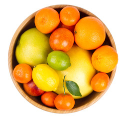 Isolated citrus fruits. Grapefruit, orange, lemon, lime and tangerines in a wooden bowl.