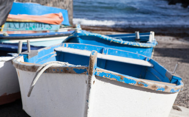 Fototapeta na wymiar Blue and white wooden fishing boats ashore on the island of Lanzarote, Spain