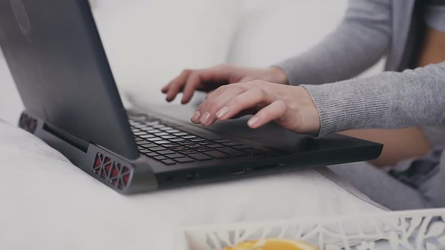 Close up. Female hands typing on a laptop keyboard. Laptop