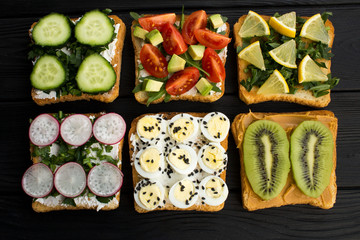 Vegetarian sandwiches  on  the black  wooden background.Top view.