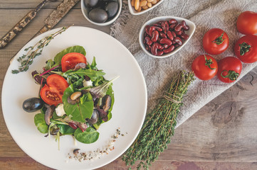 Beans red and white, olives and lettuce leaves to prepare a dietary meal for a healthy diet. The fight against excess weight. Copy space.