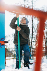 Boy have fun and smile to the camera. Smile and close eyes with snow