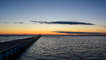 sunrise on the lake with two people