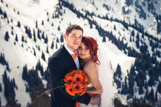 Wedding snowboarders couple just married at mountain winter