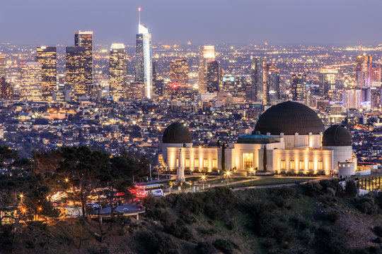 Griffith Observatory Park with Los Angeles Skyline at Dusk. Twilight views of the famous monument and downtown from Santa Monica Eastern Mountains. Los Angeles, California, USA.
