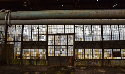 Broken windows in abandoned warehouse industrial space
