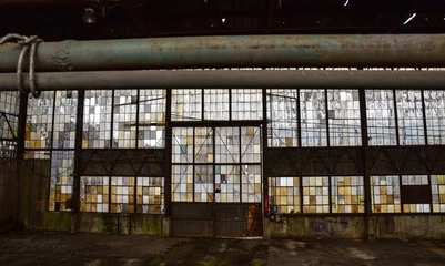 Papier Peint photo Bâtiment industriel Broken windows in abandoned warehouse industrial space