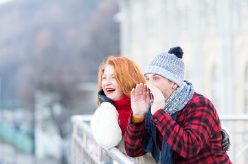 Guy crying on bridge. Men with horn and woman. Happy pair calling to friends. Urban couple have fun in city. Admired woman and men cry to.