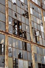 Broken windows in abandoned warehouse industrial space