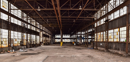 Broken windows in abandoned warehouse industrial space