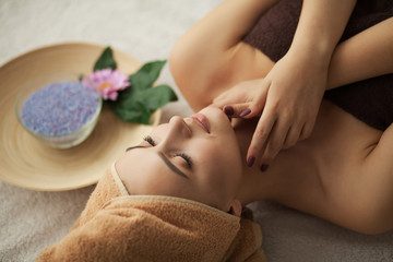 Masseur doing massage the head of an woman in spa salon