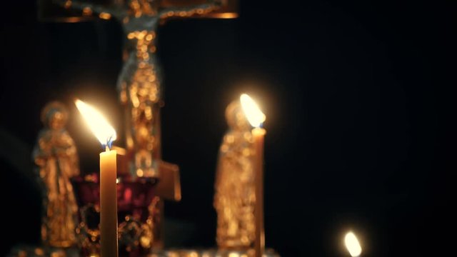 burning candles on a candlestick at the empty orthodox church
