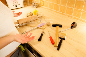 Woman choice kitchen tools or man tools. Gender equality concept.