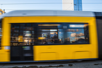 Awesome yellow trams of capital city Berlin. Special effect shot with motion blur