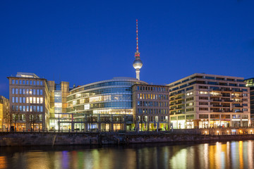 BERLIN, GERMANY - FEBRUARY 22, 2017: Night view of business buildings along Spree river and TV tower
