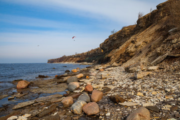 Fototapeta na wymiar Baltic sea, steep limestone coast (cliff). Early spring, Estonia.