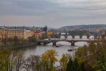 Fototapeta na wymiar Prague wide panoramic view with old town and river from hill with park Letensky garden. Gloomy weather.