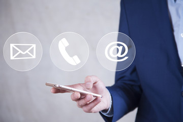 Man using a mobile phone while emitting a clouds of contact icons in a conceptual image.