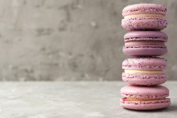 Pink and violet macarons on light background. Copy space.