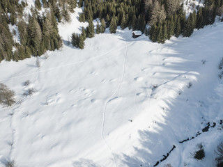 Fototapeta na wymiar Aerial view of traces in snow in Swiss mountains
