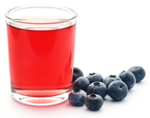 Group of fresh blueberries with juice in a glass
