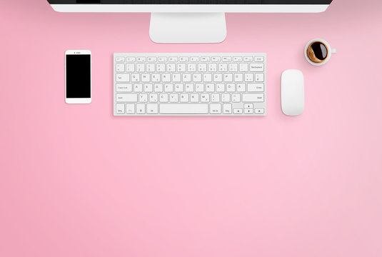 Smartphone, keyboard, desktop pc, mouse and coffee on pink desk with free space for text. Work space