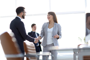 handshake between colleagues in the workplace