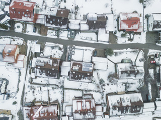 Aerial view of rooftops of German town in winter. Everything covered with snow