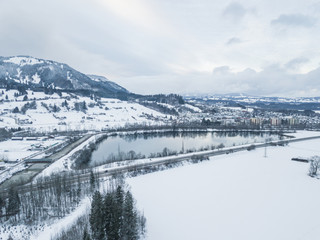 Aerial view of lake in snow covered landscape