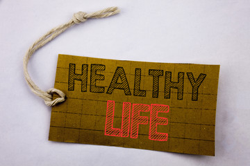 Handwriting Announcement text showing Healthy Life. Business concept for online sale Good Health Food written on price tag paper on the white vintage background.