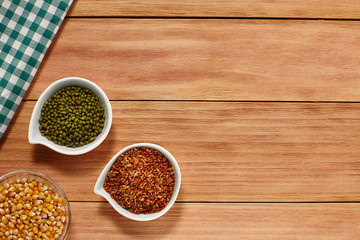 Healthy grain food and seeds in a white bowl on wood background with a Table Cloth. Top View. Copy Space.