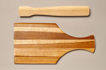 Vintage Pestle and Rustic Wooden Cutting Board isolated on Grey Background with Real Shadow. Top View with Copy Space