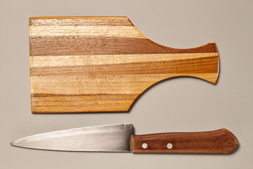 Vintage Kitchen Knife and Rustic Wooden Cutting Board isolated on Grey Background with Real Shadow. Top View