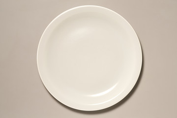 Empty Plate isolated on Grey Background with Real Shadow. Top View