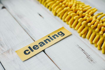 Keep your house clean and healthy with a fluffy yellow cotton mop. Contrast composition of cleaning...
