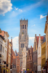 Obraz premium The Belfry Tower (aka Belfort) and traditional narrow streets in Bruges (Brugge), Belgium