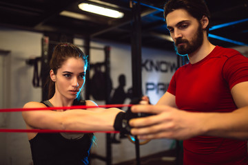 Naklejka premium Beautiful girl doing fitness exercises in gym.