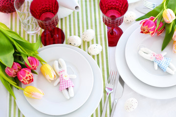 Beautiful table setting with crockery and flowers for Easter celebration