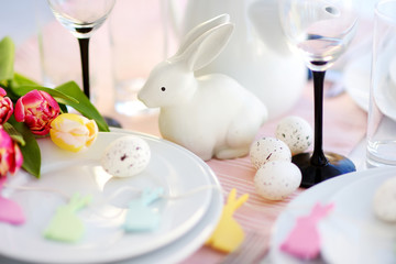 Beautiful table setting with crockery and flowers for Easter celebration