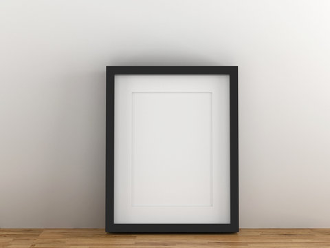 Blank black picture frame template for place image or text inside put on wood table.