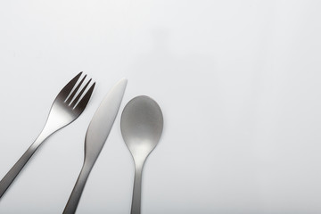 Metal inox cutlery on bright gray table