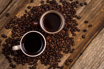 Coffee and coffee beans on old rustic wood table
